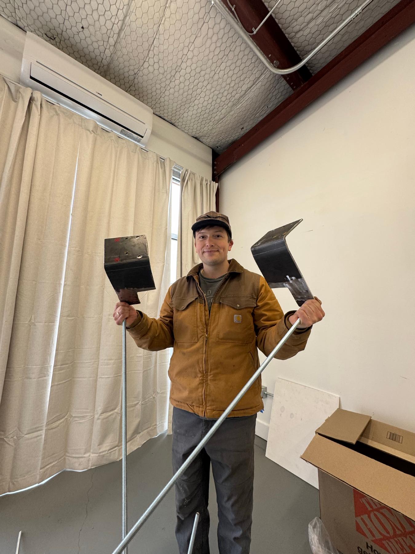 Sky holding a projector and his custom welded mounting system
