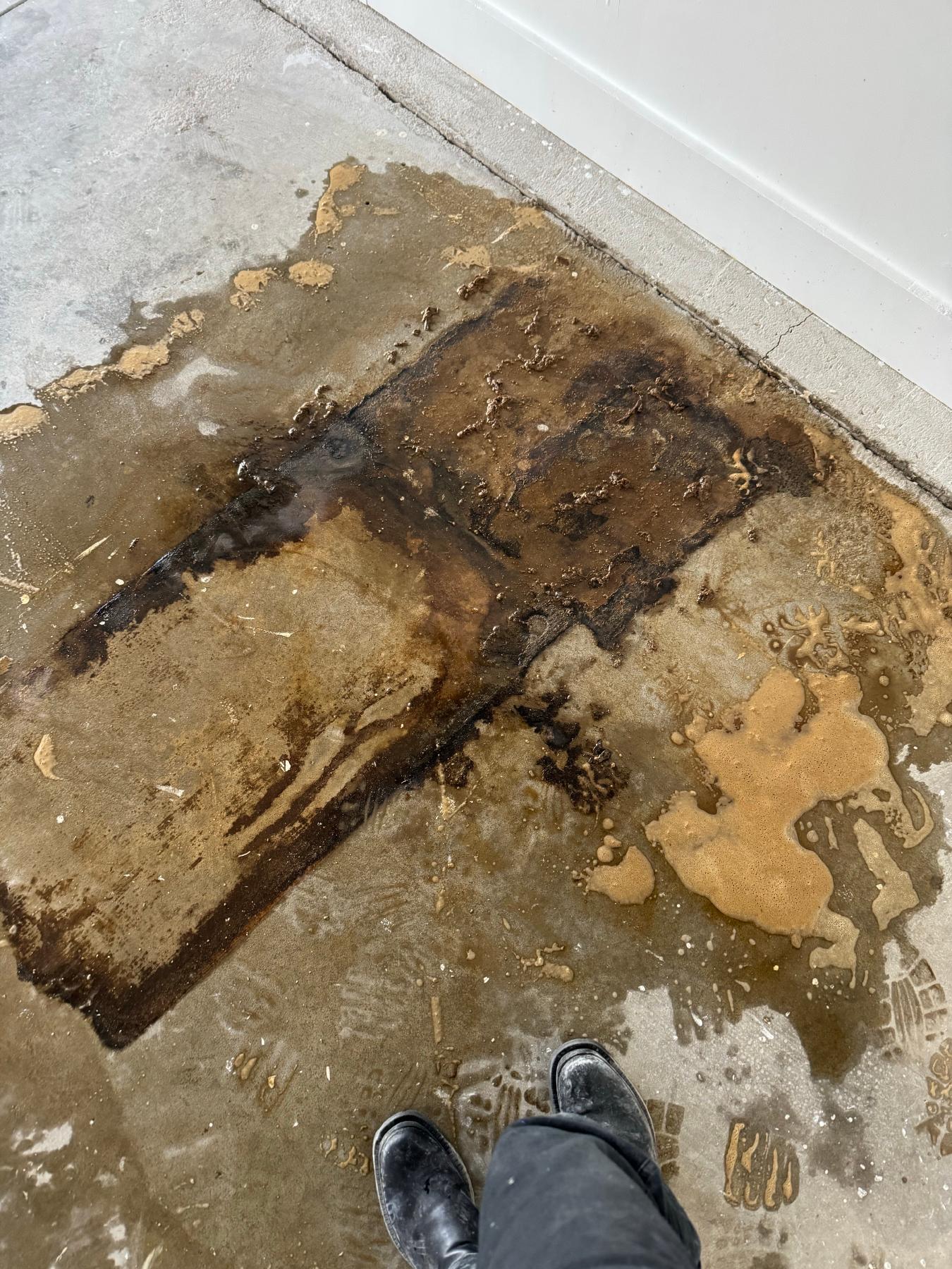 Damaged concrete workshop floor before repair